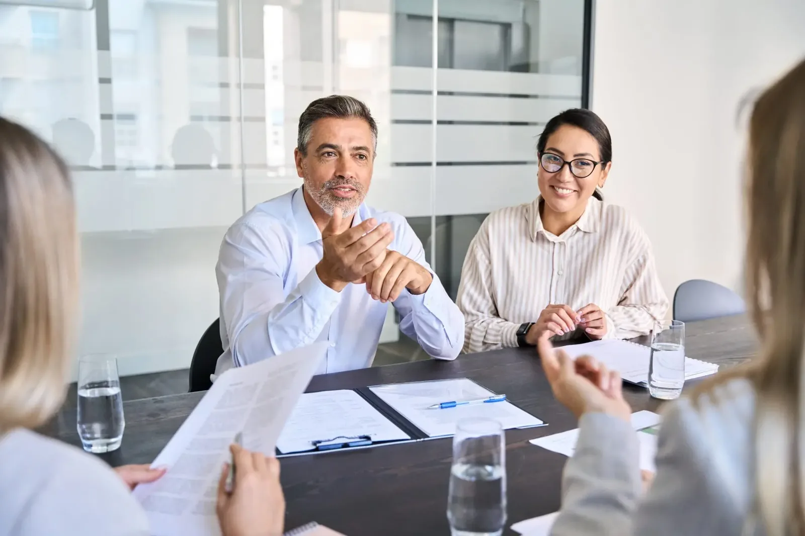 Business executives discussing sales contingency planning strategies during professional meeting