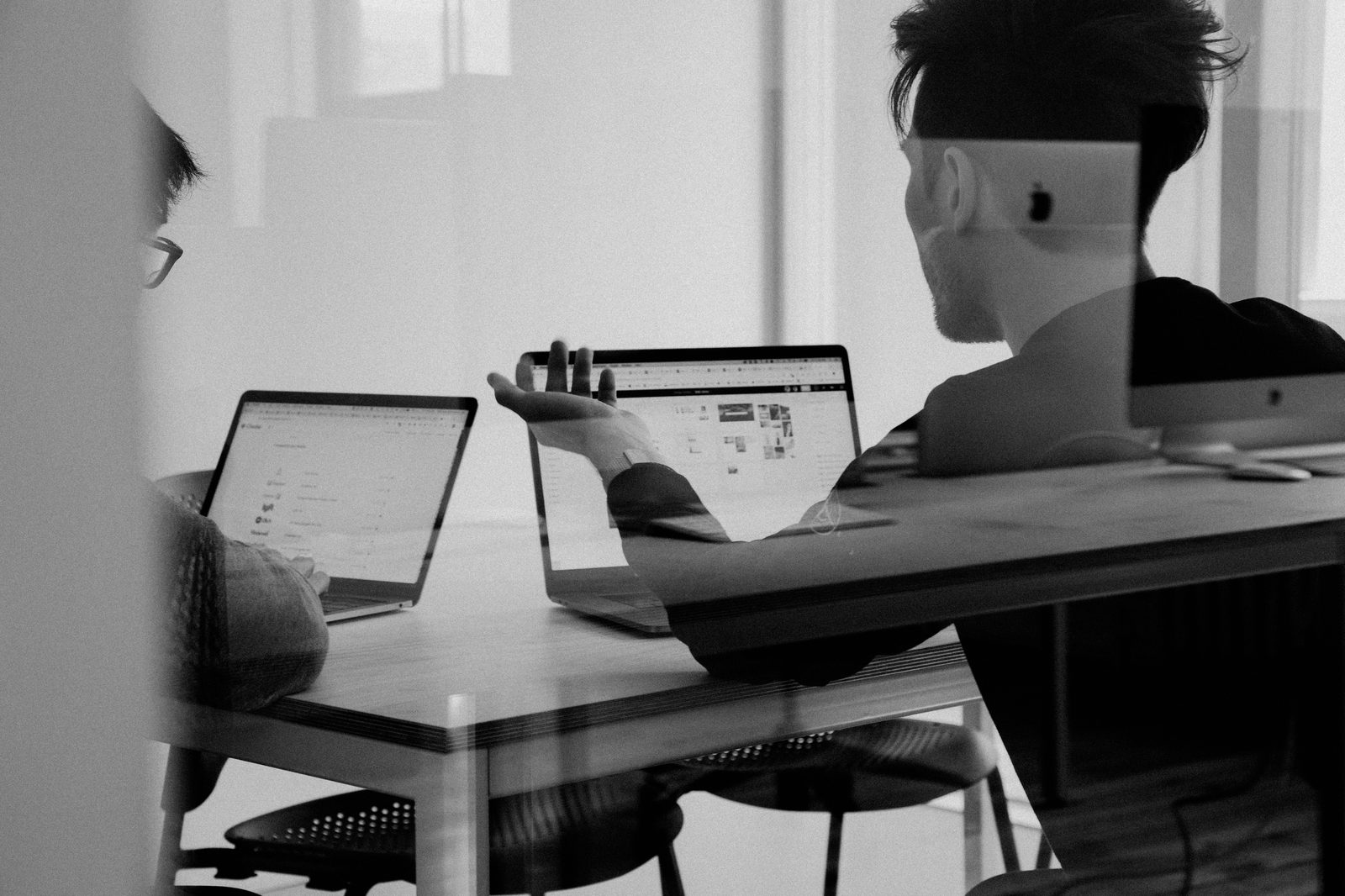 Sales professionals collaborating on value-based selling strategies at modern office workspace